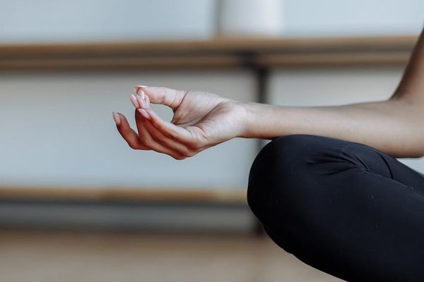 Close-up of hands in a meditative mudra gesture.